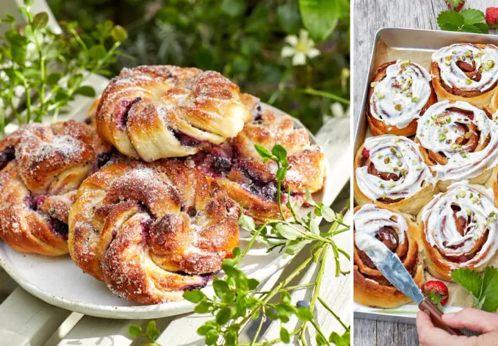 Fyllda bullar med bär och socker på en vit tallrik, bredvid en plåt med kanelbullar med glasyr och pistagenötter.