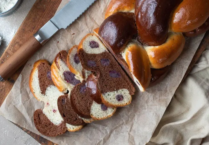 En vackert flätad vetelängd med mandelmassa och mörka bär. Skivorna visar en härlig kontrast mellan ljust och mörkt bröd.